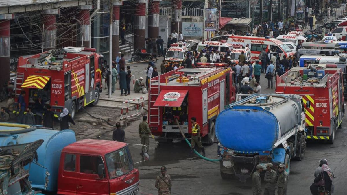 Fire trucks outside a mall in India where at least 10 people died from a fire.
